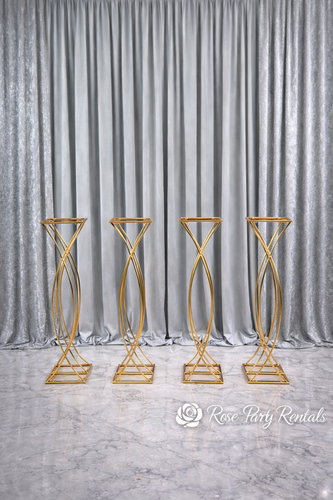 Gold twist pedestal stands on silver drape